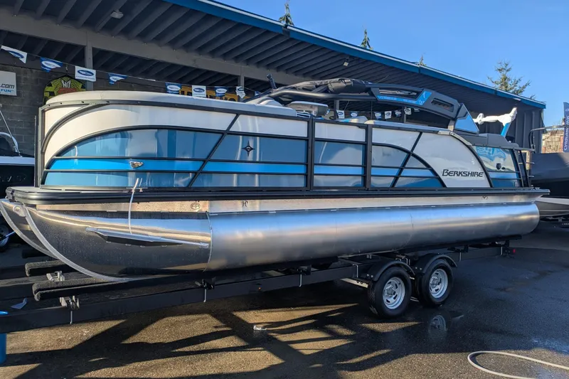 Slide: The Image of 2026 Berkshire 23SB2 STS pontoon boat on trailer, displayed outdoors. - 2
