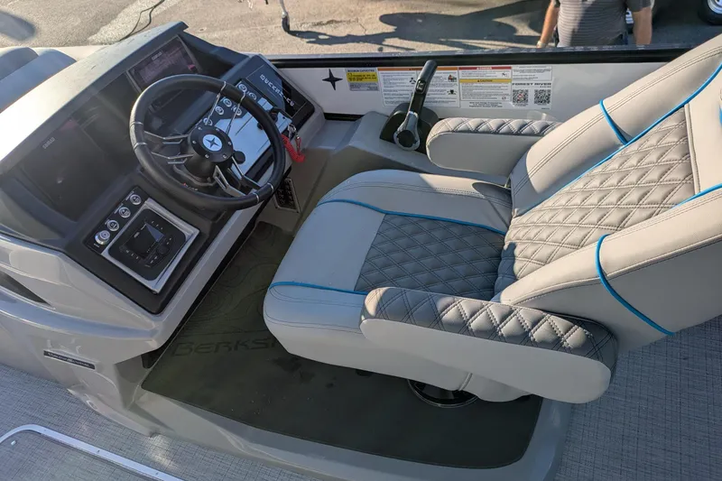 Slide: The Image of Luxurious interior of 2026 Berkshire 23SB2 STS boat with quilted captain's chair and modern dashboard. - 5