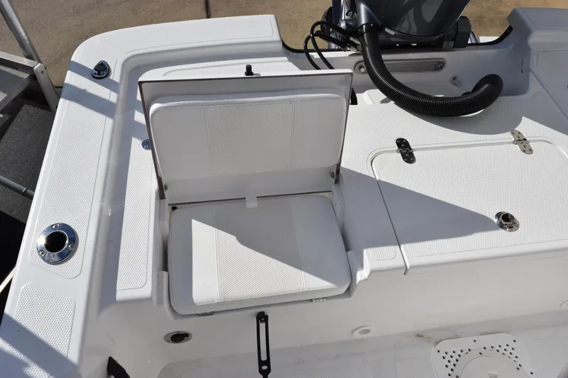 Slide: The Image of White seating area on a 2026 Frontier 2104 boat, featuring storage compartments. - 11