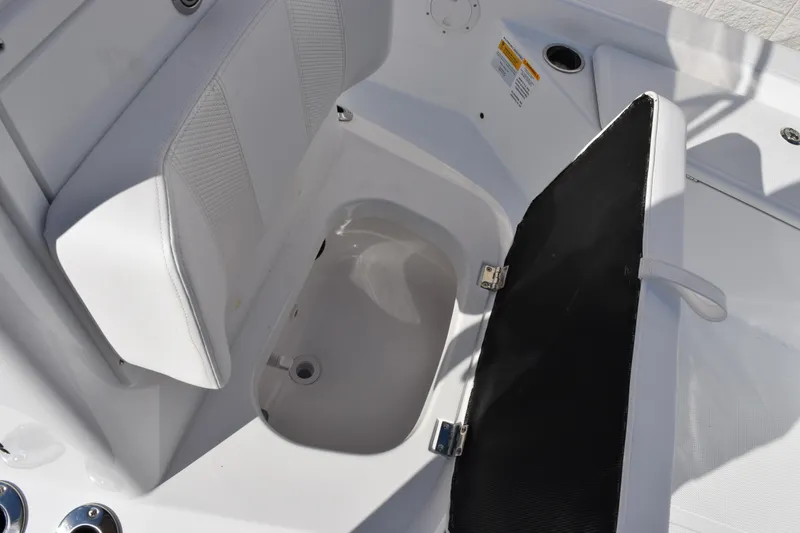 Slide: The Image of Open storage compartment on 2026 Frontier 2104 boat with cushioned seating. - 13