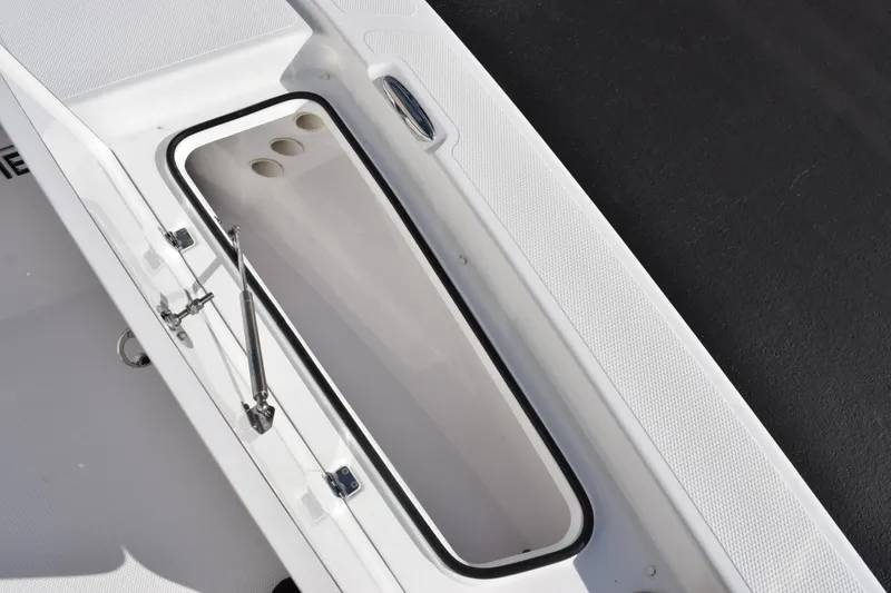 Slide: The Image of Open storage compartment on 2026 Frontier 2104 boat, showcasing interior design. - 14