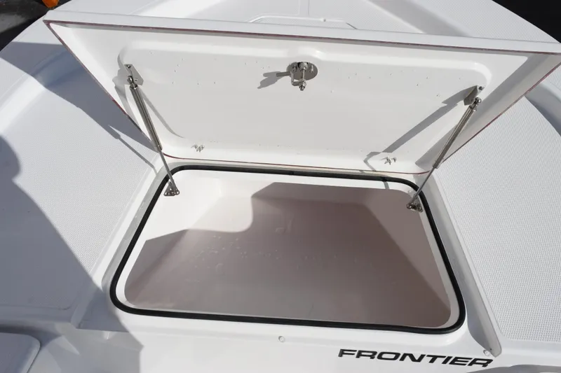 Slide: The Image of Open storage compartment on 2026 Frontier 2104 boat, featuring secure latch and hydraulic supports. - 15