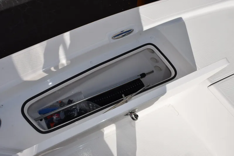 Slide: The Image of Open storage compartment on 2026 Frontier 2104 boat, showing equipment and accessories. - 16