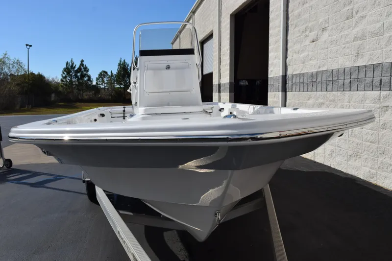 Slide: The Image of 2026 Frontier 2104 boat on trailer, parked outside a building. - 3