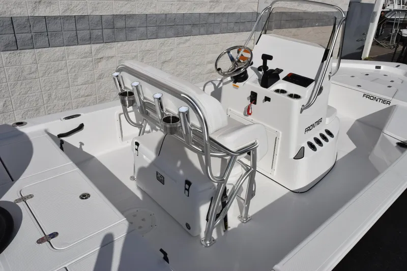 Slide: The Image of 2026 Frontier 2104 boat interior with steering console and seating. - 8