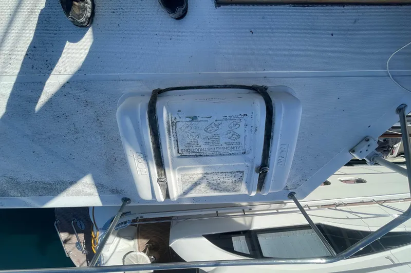 Slide: The Image of 1990 Spindrift COCKPIT MOTORYACHT deck with secured equipment and visible railing. - 10