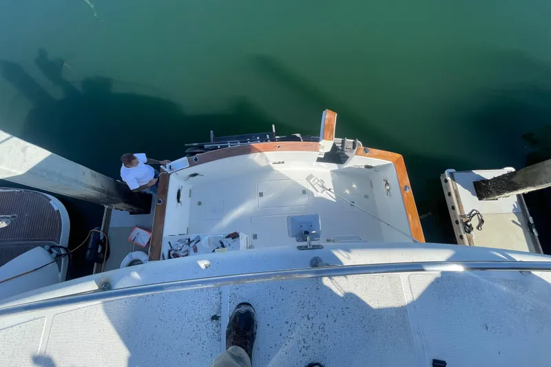 Slide: The Image of Overhead view of 1990 Spindrift Cockpit Motoryacht docked, with person on deck. - 11