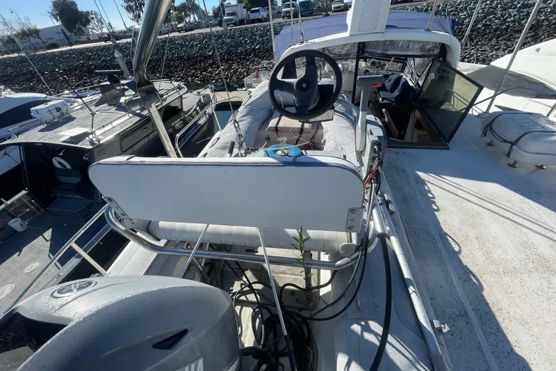 Slide: The Image of 1990 Spindrift COCKPIT MOTORYACHT docked, showcasing steering wheel and open cabin entrance. - 15