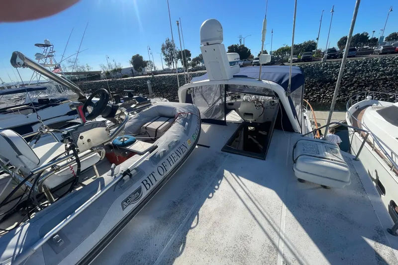 Slide: The Image of 1990 Spindrift COCKPIT MOTORYACHT docked with inflatable boat on deck. - 16