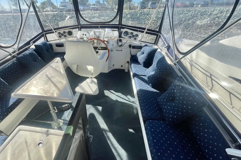 Slide: The Image of Interior of 1990 Spindrift Cockpit Motoryacht with blue seating and helm station. - 17