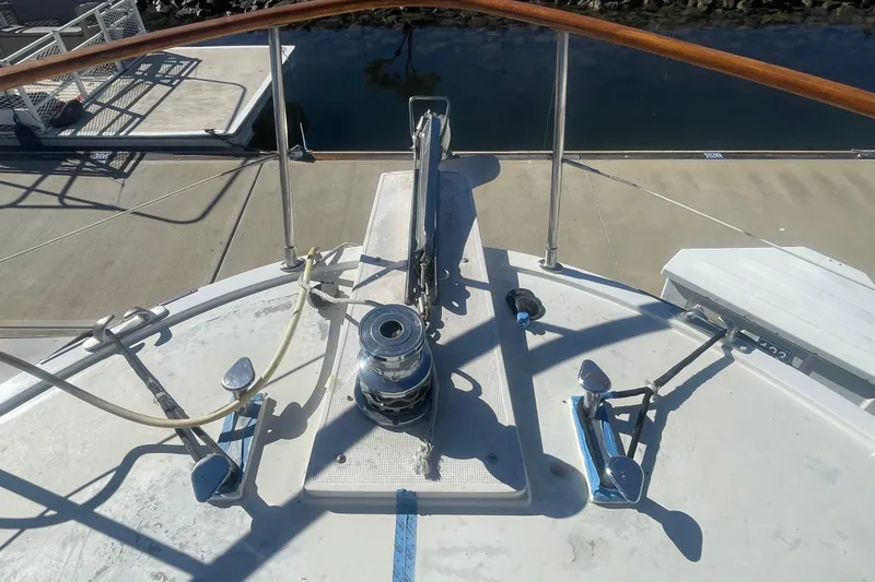 Slide: The Image of Bow view of 1990 Spindrift COCKPIT MOTORYACHT at dock, featuring deck equipment. - 2
