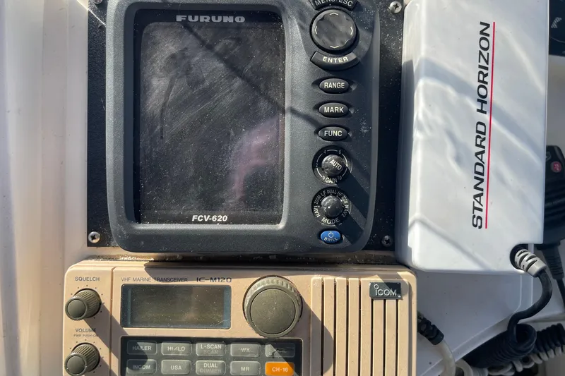 Slide: The Image of Control panel of a 1990 Spindrift Cockpit Motoryacht featuring Furuno and Standard Horizon equipment. - 20