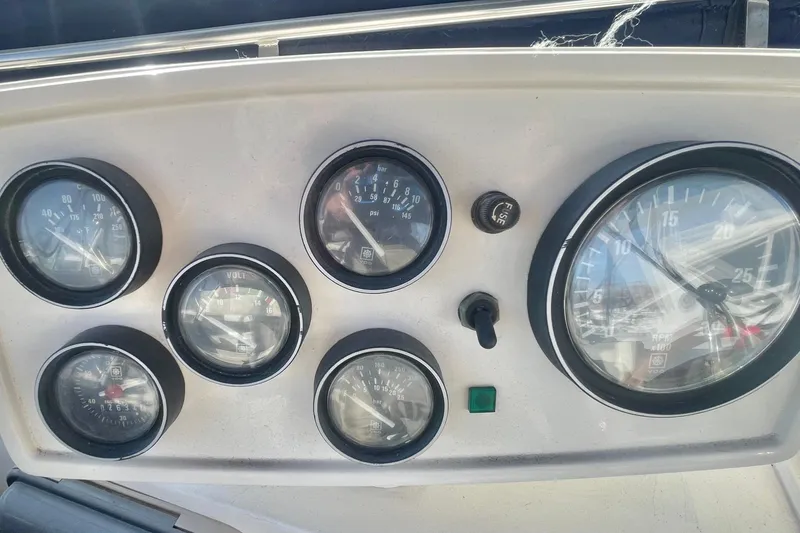 Slide: The Image of Instrument panel of a 1990 Spindrift Cockpit Motoryacht with gauges and controls. - 23