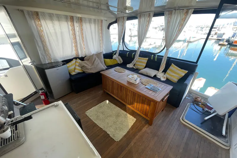 Slide: The Image of Interior of 1990 Spindrift Cockpit Motoryacht with cozy seating and marina view. - 26