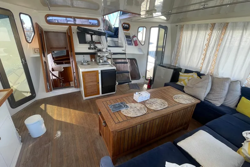 Slide: The Image of Interior of 1990 Spindrift Cockpit Motoryacht with cozy seating and wooden accents. - 28