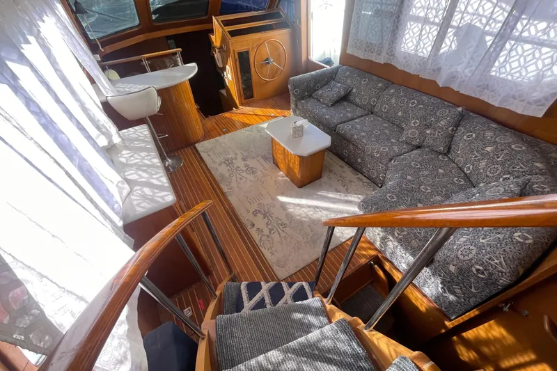 Slide: The Image of Interior of a 1990 Spindrift Cockpit Motoryacht with elegant seating and wooden accents. - 31