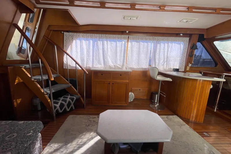 Slide: The Image of Interior of 1990 Spindrift Cockpit Motoryacht with wooden decor and modern furnishings. - 33