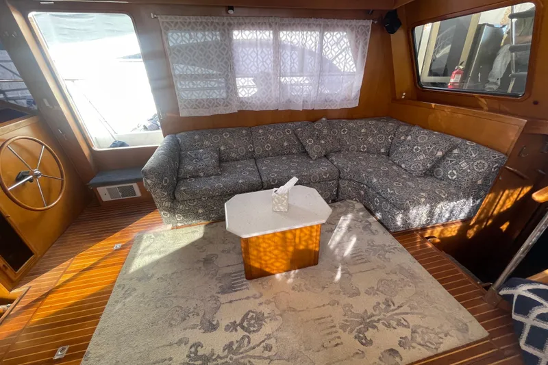 Slide: The Image of Interior of 1990 Spindrift Cockpit Motoryacht with patterned sofa and wooden accents. - 34