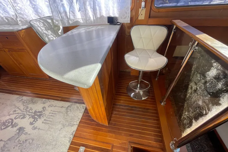 Slide: The Image of 1990 Spindrift Cockpit Motoryacht interior with wooden flooring and modern seating. - 35