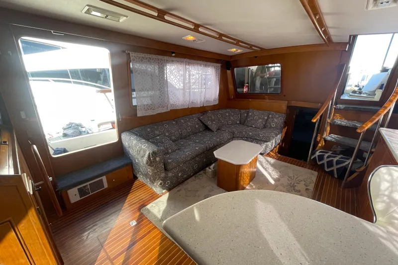Slide: The Image of Interior of 1990 Spindrift Cockpit Motoryacht with cozy seating and wooden accents. - 36