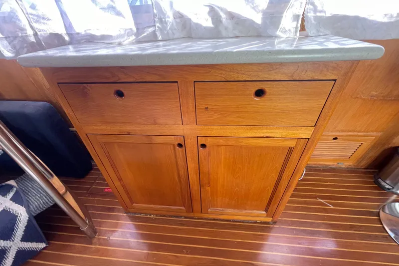 Slide: The Image of Wooden cabinet with drawers in a 1990 Spindrift Cockpit Motoryacht interior. - 38