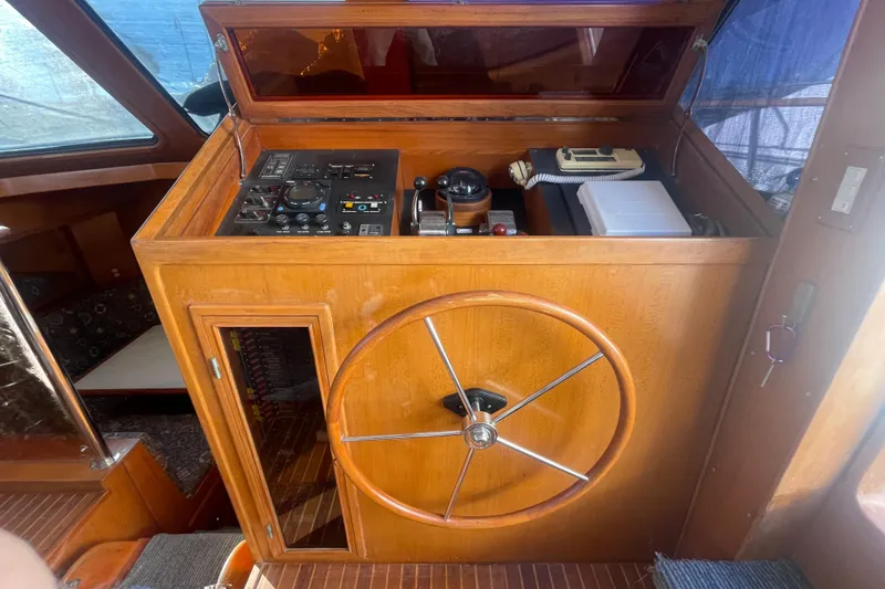 Slide: The Image of 1990 Spindrift Cockpit Motoryacht helm with wooden wheel and control panel. - 39