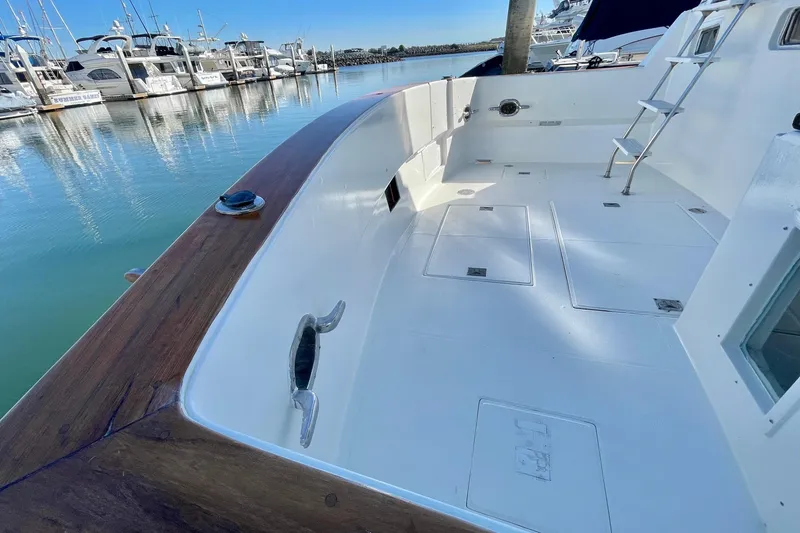 Slide: The Image of 1990 Spindrift Cockpit Motoryacht with spacious deck, docked in a serene marina. - 4