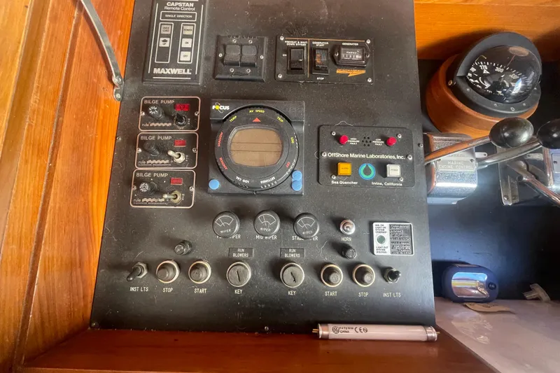 Slide: The Image of Control panel of a 1990 Spindrift COCKPIT MOTORYACHT with various switches and gauges. - 41