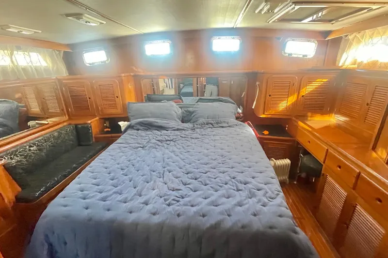 Slide: The Image of Luxurious cabin interior of 1990 Spindrift Cockpit Motoryacht with cozy bed and wooden furnishings. - 50