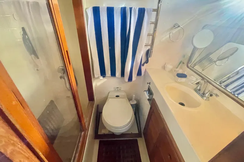 Slide: The Image of Bathroom in 1990 Spindrift Cockpit Motoryacht with shower, toilet, and sink. - 52