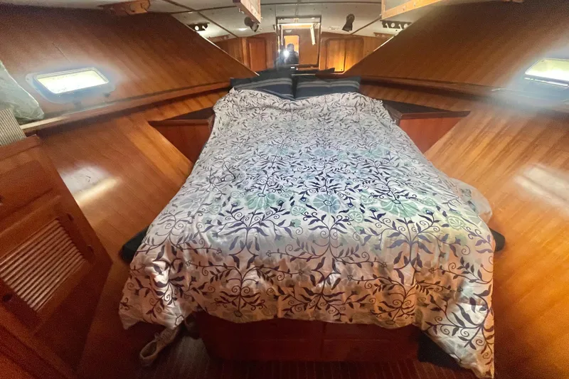 Slide: The Image of Cozy cabin interior of 1990 Spindrift Cockpit Motoryacht with patterned bedding. - 56