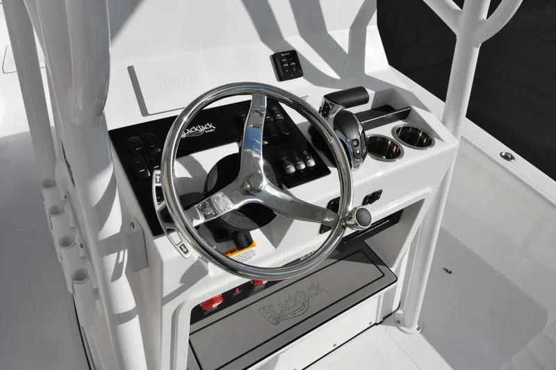 Slide: The Image of Steering console of 2026 BlackJack 256 Bay boat with chrome wheel and controls. - 10