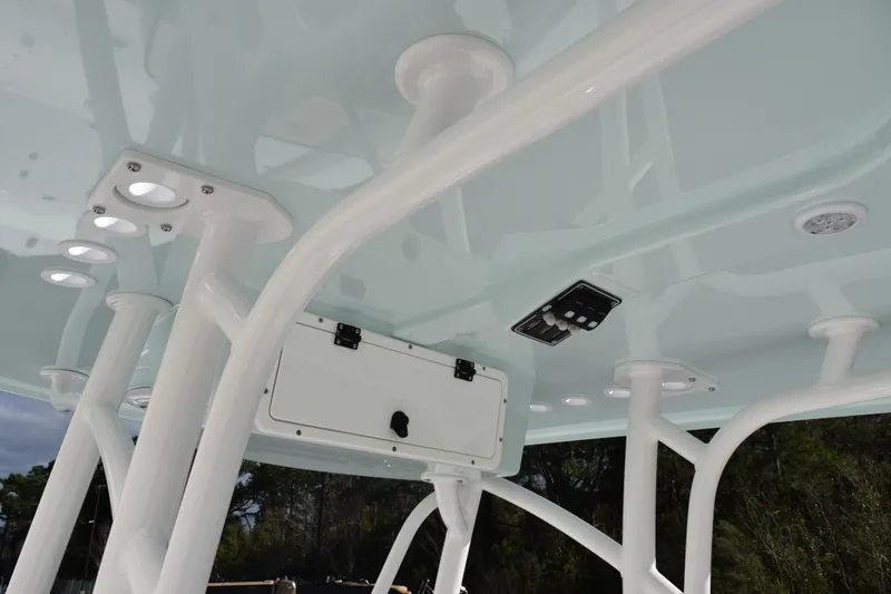 Slide: The Image of T-top view of 2026 BlackJack 256 Bay boat with rod holders and control panel. - 11