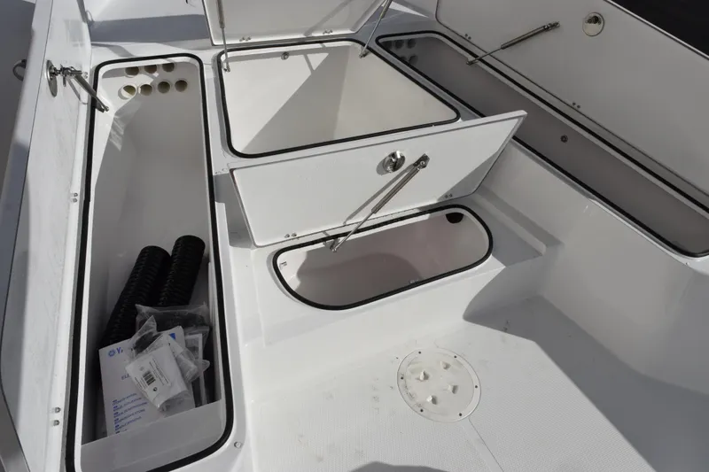 Slide: The Image of 2026 BlackJack 256 Bay boat storage compartments with open hatches and visible equipment. - 14