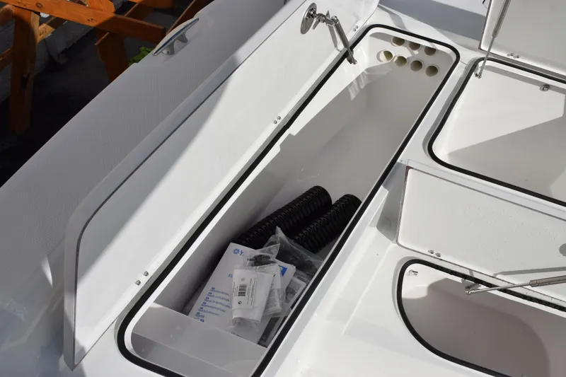Slide: The Image of Storage compartments on a 2026 BlackJack 256 Bay boat, featuring organized equipment. - 15