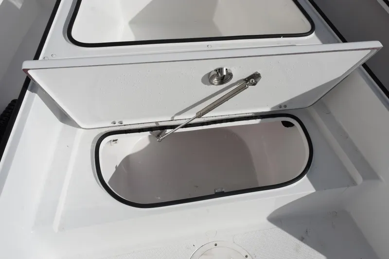Slide: The Image of Open storage compartment on 2026 BlackJack 256 Bay boat, showcasing interior space. - 16