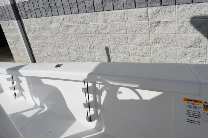 Slide: The Image of 2026 BlackJack 256 Bay boat interior with rod holders and warning label. - 18