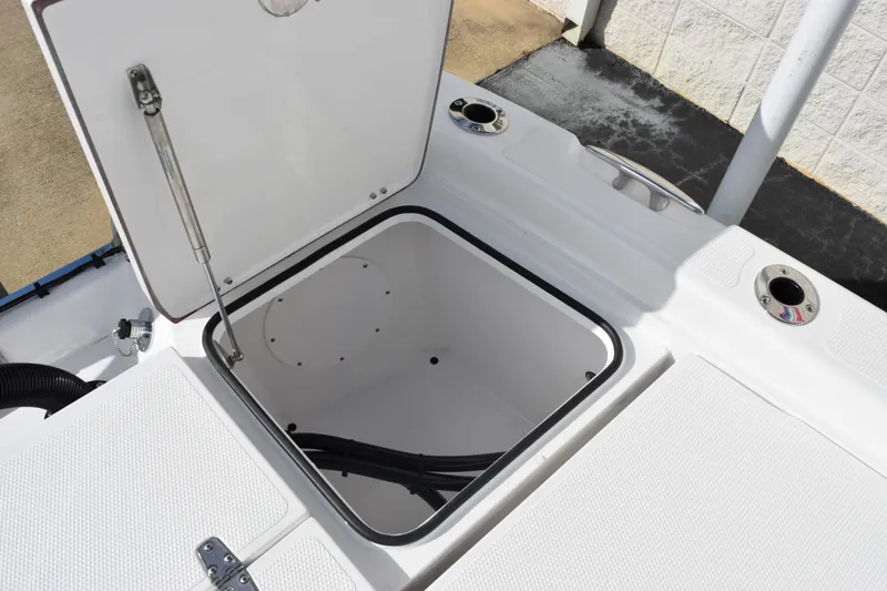 Slide: The Image of Open storage compartment on 2026 BlackJack 256 Bay boat deck. - 20
