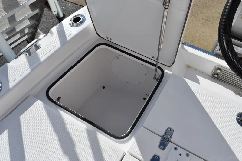 Slide: The Image of Open storage compartment on 2026 BlackJack 256 Bay boat deck. - 21