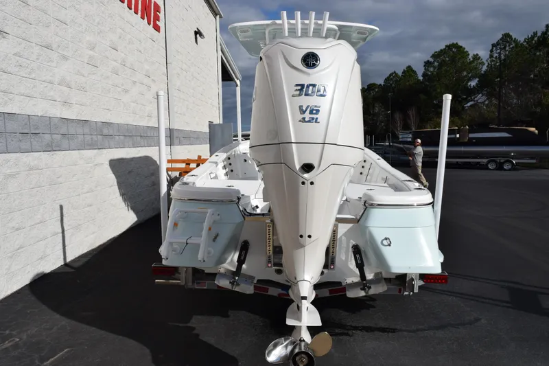 Slide: The Image of 2026 BlackJack 256 Bay boat with powerful 300 V6 engine, parked outside a marine store. - 5