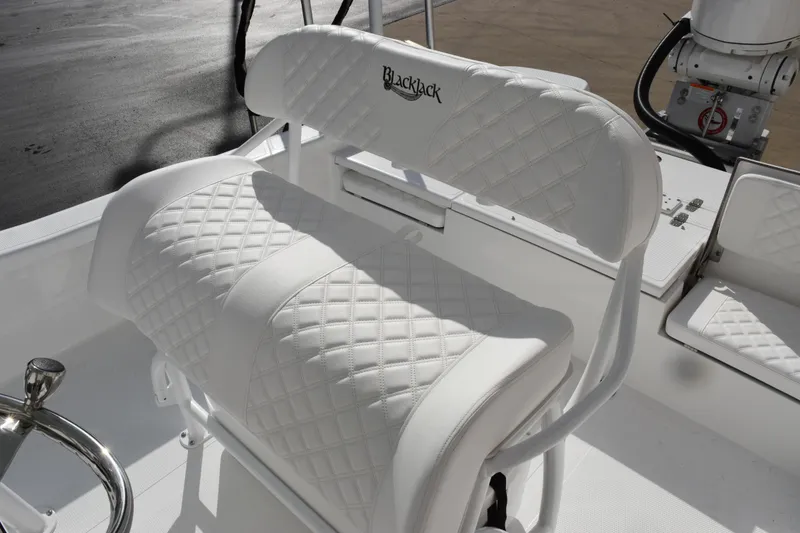 Slide: The Image of White leather seating on 2026 BlackJack 256 Bay boat, featuring diamond stitching. - 9