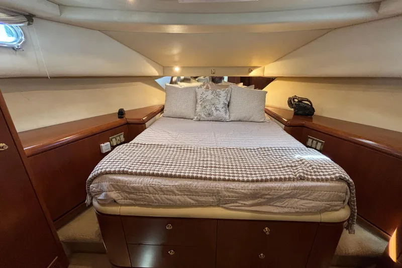 Slide: The Image of Luxurious 1996 Queenship yacht bedroom with cozy bedding and elegant wood cabinetry. - 10