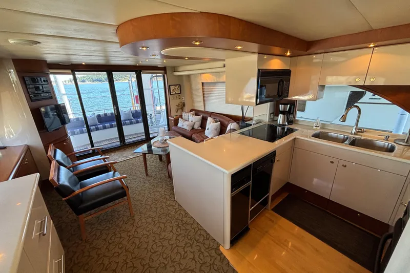 Slide: The Image of Luxurious 1996 Queenship yacht interior with modern kitchen and cozy seating area. - 16