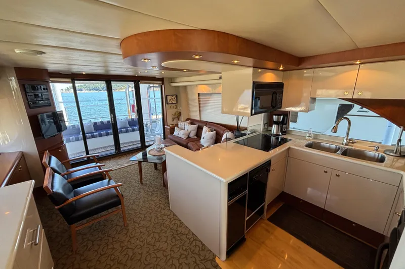 Slide: The Image of Luxurious 1996 Queenship yacht interior with modern kitchen and cozy seating area. - 17