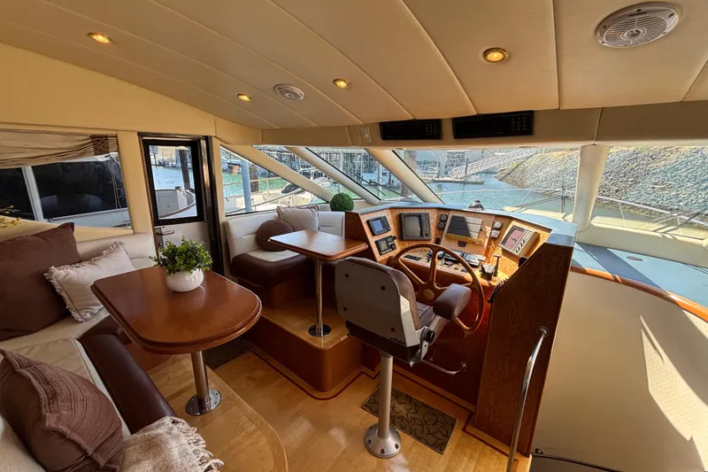 Slide: The Image of Luxurious 1996 Queenship yacht interior with helm, plush seating, and elegant wood finishes. - 19