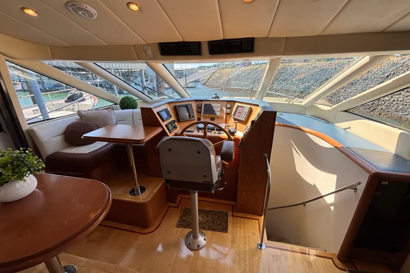 Slide: The Image of Luxurious 1996 Queenship yacht interior with helm, seating, and panoramic windows. - 22