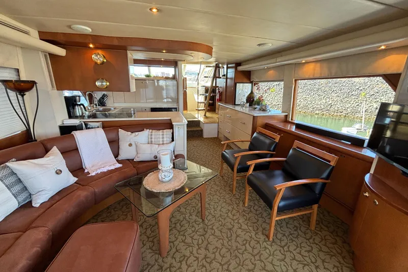 Slide: The Image of Luxurious 1996 Queenship yacht interior with elegant seating, modern kitchen, and large windows. - 25