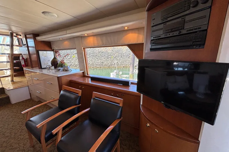 Slide: The Image of Luxurious 1996 Queenship yacht interior with modern entertainment system and elegant seating. - 28