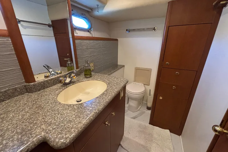 Slide: The Image of Luxurious 1996 Queenship yacht bathroom with granite countertop and wooden cabinetry. - 3