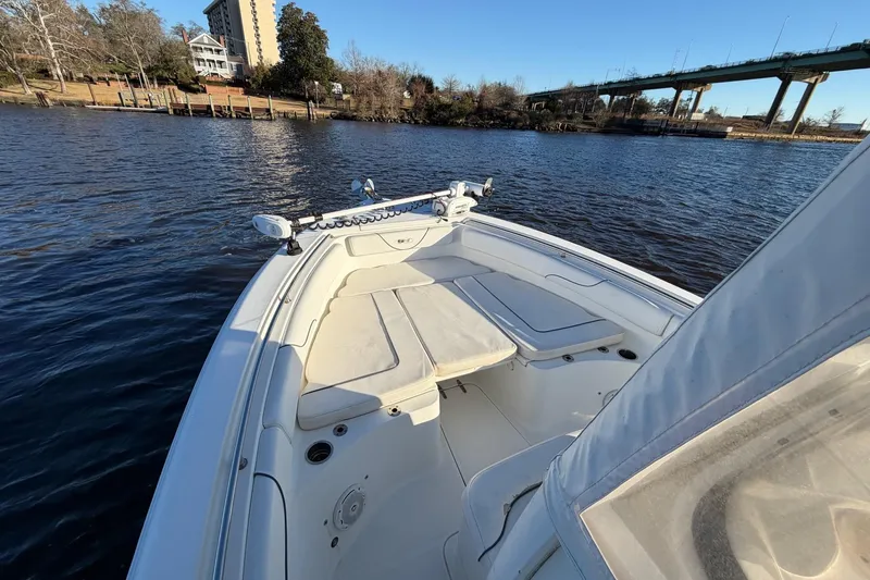 Slide: The Image of 2015 Sea Hunt Gamefish 25 boat on calm water near a bridge and shoreline. - 6